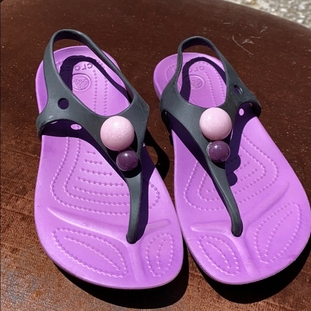 Purple and black Crocs sandals
